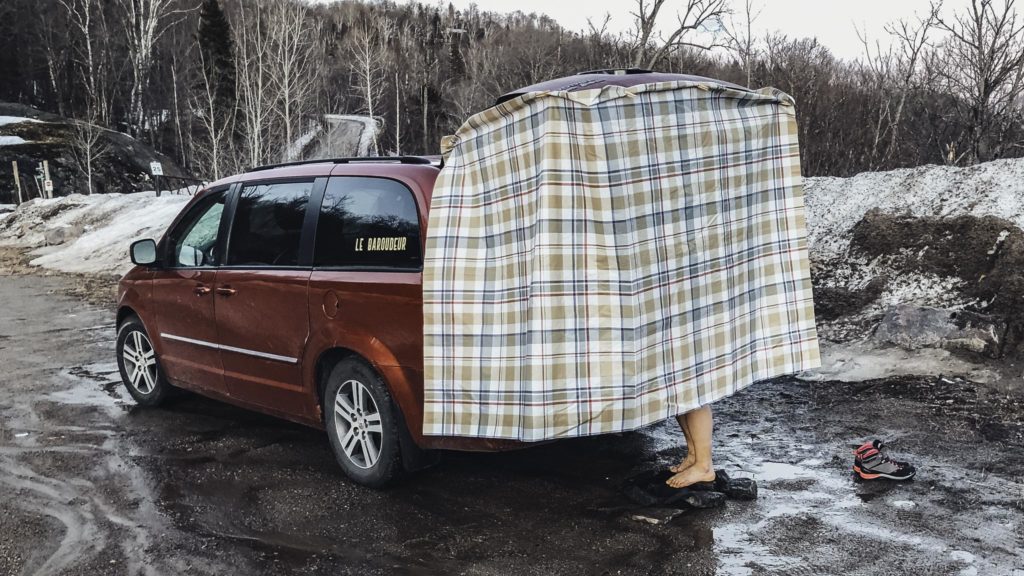 A homemade shelter on the trunk of a Vanpacker minivan in winter